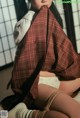 A woman in a kimono is tied up with a rope.