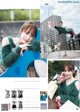 A woman in a green sweater is posing for a magazine.
