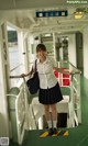 A woman in a school uniform standing on a boat.